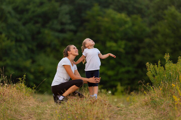 Fototapeta premium mother and daughter exercising outdoors