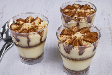 delicious homemade tiramisu in glasses on a table
