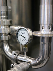 Detail of the barometer on a machine in a brewery.