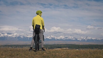 The man travel on mixed terrain cycle touring with bikepacking. The traveler journey with bicycle...