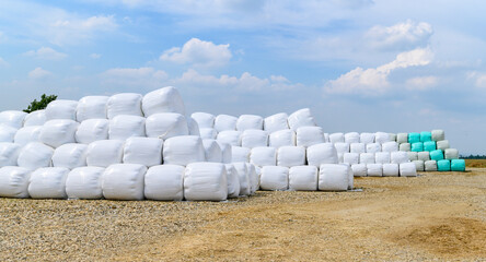 Hay bales on a rural countryside farmland ready for livestock wrapped in plastic