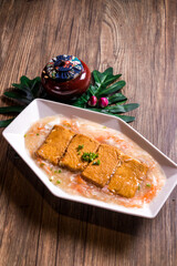 deep fried tofu beancurd with braised mushroom egg crabmeat thick sauce on wood table chinese banquet halal menu