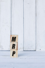 mrp concept written on wooden cubes or blocks, on white wooden background.