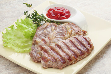 Grilled pork neck steak with ketchup
