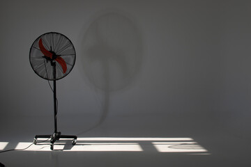 Fan or ventilator and shadows from the window on the floor