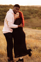 Portrait of attractive African American man gently hug beautiful white woman, adorable lady smiling, enjoy tender moments, spend time together, mixed race couple concept