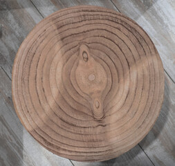 Top view section of tree trunk, tribal object isolated on wooden background