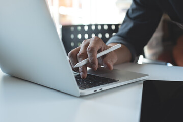 Close up of man hand working remotely on laptop computer at home. Creative designer, freelancer work at studio office