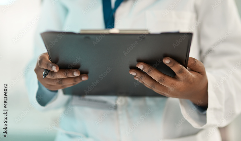 Poster keeping a log of the latest data. closeup shot of an unrecognisable scientist holding a clipboard in