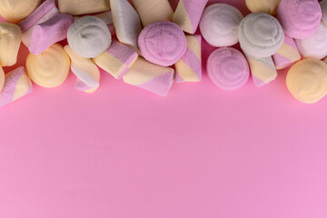 Colored marshmallow on a delicate pink background.Copy space.