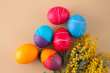 Easter eggs. Festive decoration. Easter. Celebration. Bright holiday. Eggs on a beige background. Multi-colored eggs on a beige background.