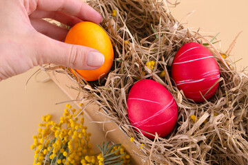 Easter eggs. Festive decoration. Easter. Celebration. Bright holiday. Eggs on a beige background. Multi-colored eggs on a beige background.