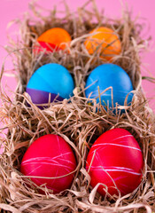 Easter eggs. Festive decoration. Easter. Celebration. Bright holiday. Eggs on a pink background. Multi-colored eggs on a pink background.