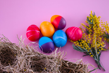Easter eggs. Festive decoration. Easter. Celebration. Bright holiday. Eggs on a pink background. Multi-colored eggs on a pink background.
