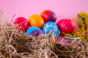 Easter eggs. Festive decoration. Easter. Celebration. Bright holiday. Eggs on a pink background. Multi-colored eggs on a pink background.