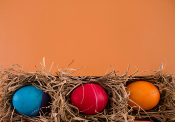 Easter eggs. Festive decoration. Easter. Celebration. Bright holiday. Eggs on an orange background. Multi-colored eggs on an orange background.