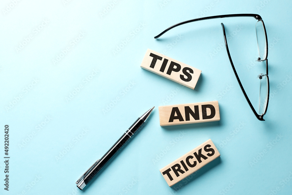 Poster tips and tricks text on the wooden block ,blue background
