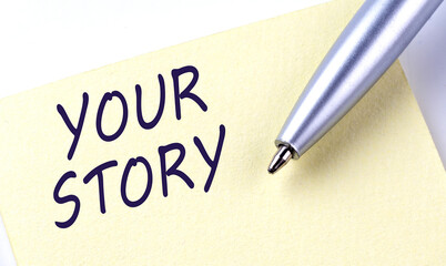 Sticky Note Message YOUR STORY with pen on white background