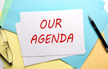 OUR AGENDA text on paper on the colorful paper background