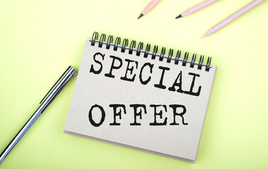 SPECIAL OFFER text on the notebook with pen on yellow background