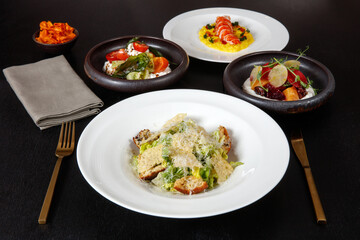 Beautiful non-veg dish on white plates with salad dressings.