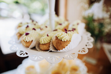 Desserts at a holiday party in a restaurant. Eclairs with cream