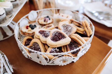Heart shaped cookies with jam. Sweets at the party