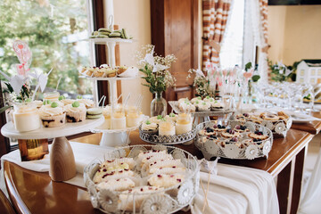Table with a variety of sweets. Cookies, chocolate, cakes, eclairs