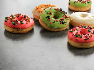 Assorted Doughnut with Colorful Sprinkle Isolated on Grey Cement Background, Copy Space for Text