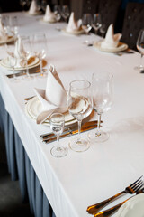 Serving a festive table in a restaurant. Preparation of a banquet for a holiday. Expensive decoration materials. Dishes for food and drinks