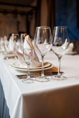 Serving a festive table in a restaurant. Preparation of a banquet for a holiday. Expensive decoration materials. Dishes for food and drinks