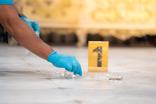 Forensic Scientist At the murder scene to collect evidence.