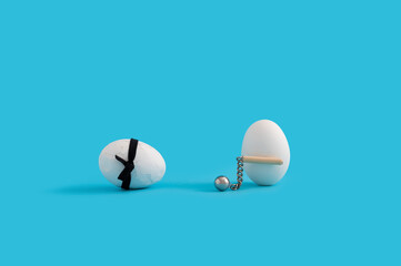 Easter layout with white eggs, one wearing black karate belt and one having medieval mace