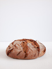 Baked bread of sourdough. Artisan bread on a light background. The bread of sourdough, homemade, and natural creation. 