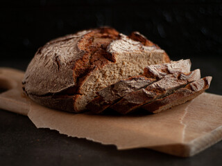 Sliced rye bread on a cutting wooden board. Whole-grain rye bread