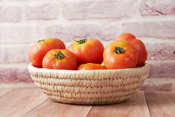 fresh tomato with water drop in a bowl on table 