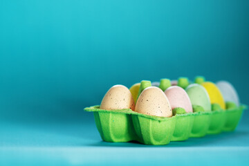easter eggs painted multi-colored in a box with copy space