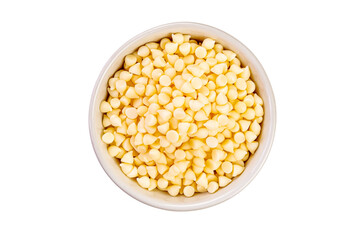 Top view of white chocolate chips in ceramic cup on white background.