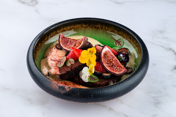 Chocolate cake with figs, blueberries and brownie Closeup