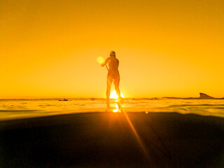Fototapeta na wymiar paddleboarding at sunrise 