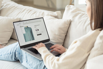 Young woman shopping online at a clothing store, electronic shopping