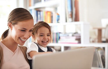 Showing her how to surf. Shot of a mother using a laptop with her daughter.