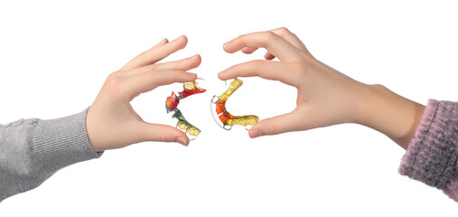 Two children's hands with orthodontic appliances on a white background. The concept of oral hygiene in childhood.
