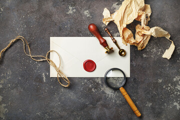 Vintage postal stationery on concrete background. Blank envelope, sealing wax, stamp, spoon,...