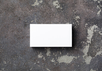 Photo of blank business card on concrete background. Template for branding ID. Flat lay.