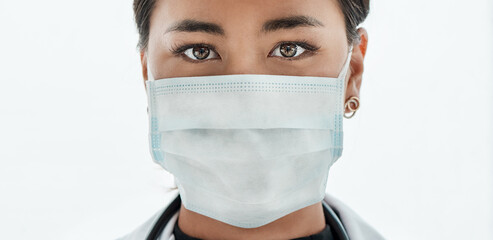 Protection is paramount during a pandemic. Portrait of a young doctor wearing a face mask.