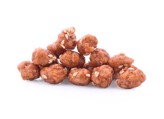 Honey covered, coated peanuts with sesame seeds isolated on white background