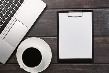 Notepad with a cup of coffee and laptop computer. Place for text. Online learning and work concept