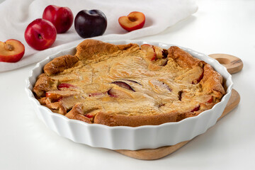 Delicate French dessert clafoutis with plums. Reminiscent a bit of both a pie and a casserole. Plums give it a pleasant sourness.