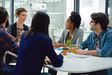 Around the boardroom table. Shot of a group of creative businesspeople meeting in the boardroom.